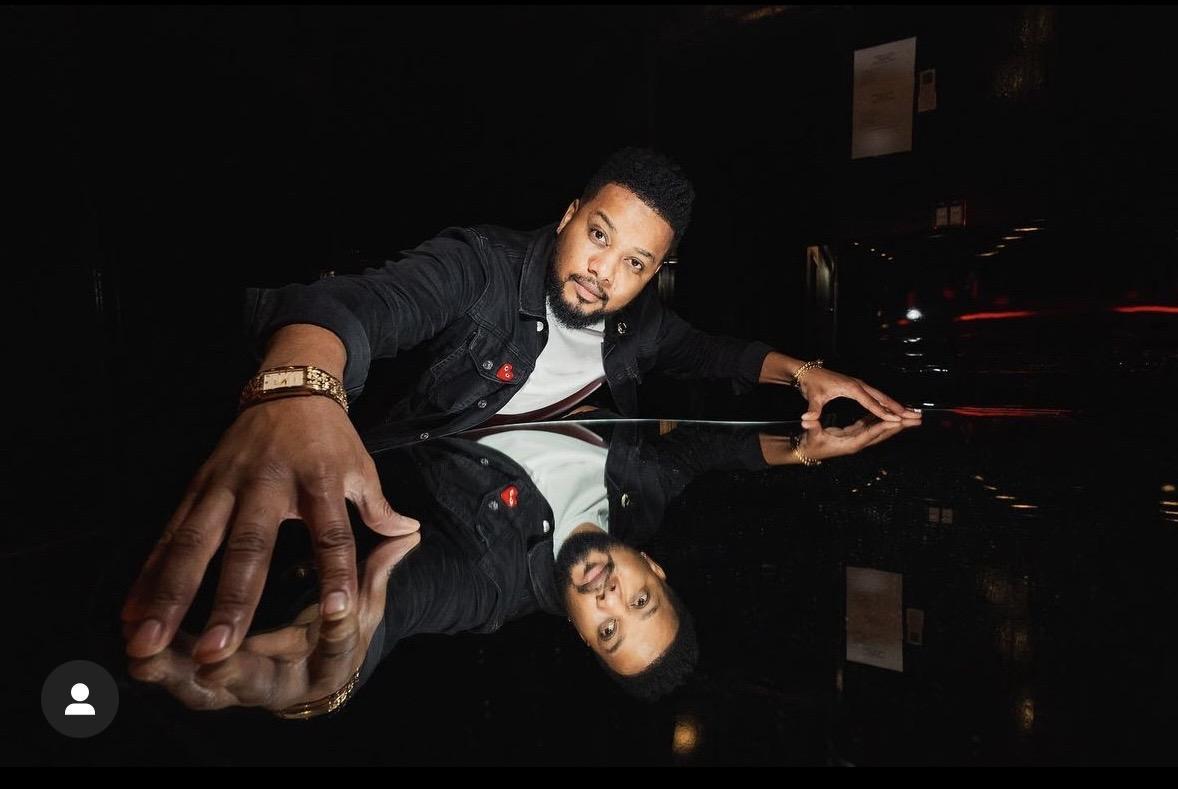 Ron G leaning over a reflective surface